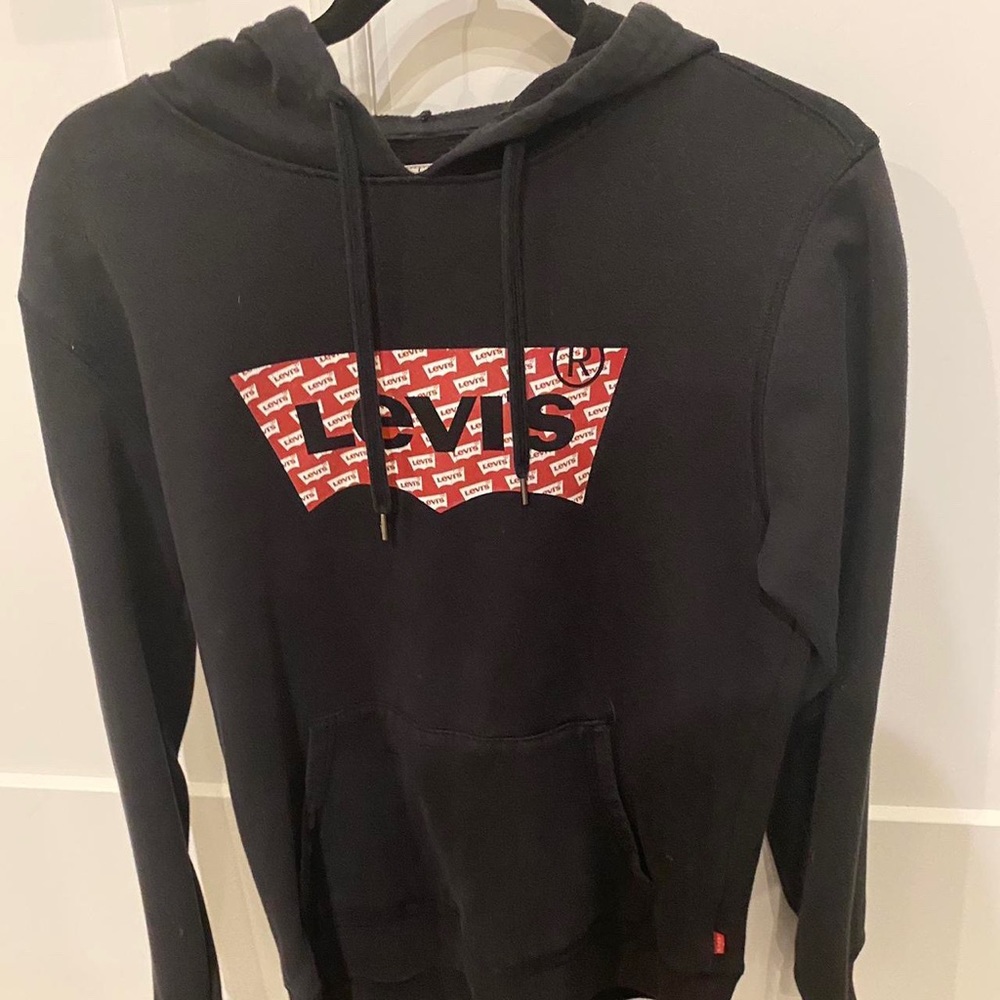 - Black hoodie with Red and White writing on it -